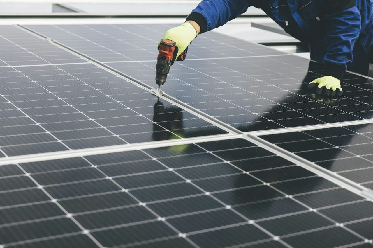 Technician installing a solar panel